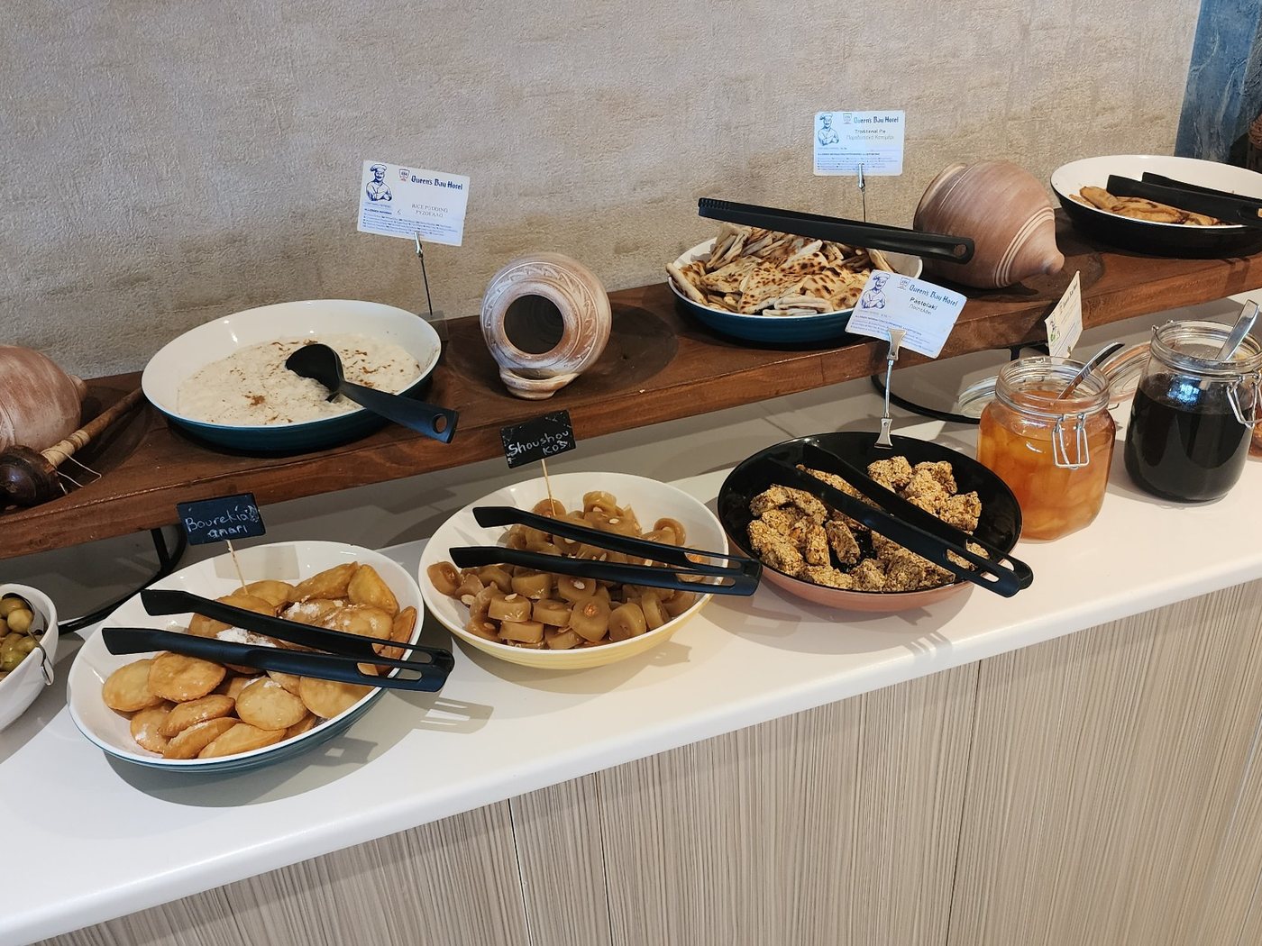 Greek breakfast buffet with olives, pastries, honey and preserves